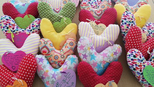 Verschiedene bunte Stoffherzen mit Spruchkarten